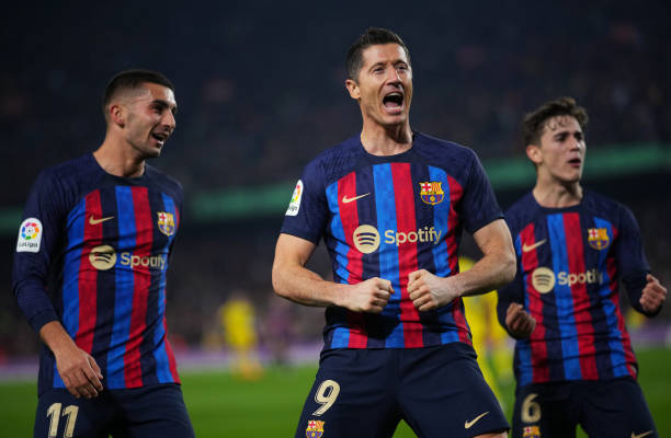 Robert Lewandowski equalled Lionel Messi for most goals in Champions League history and tied Cristiano Ronaldo’s record after scoring two penalties in Barcelona’s thrilling win over Benfica.