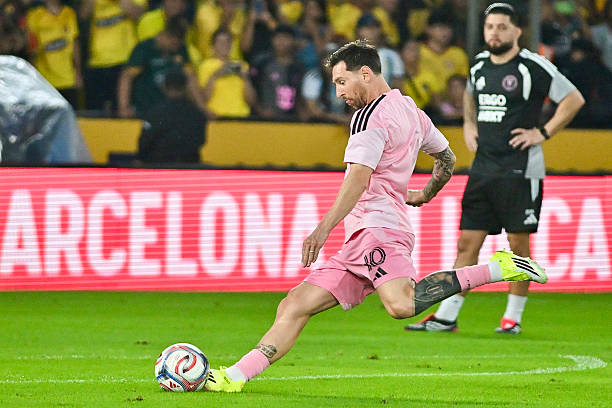 Lionel Messi Injury Inter Miami in pink jersey kicking ball.